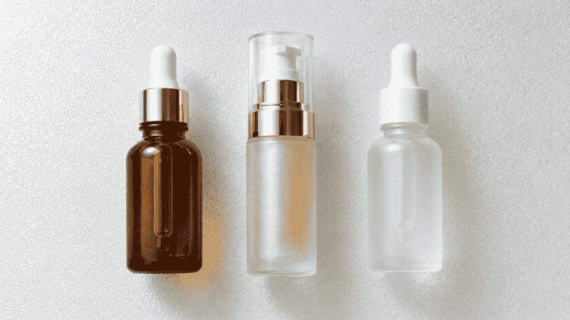 Three luxury serums side by side — retinol, vitamin C and peptides as the proven ingredients to stimulate collagen production