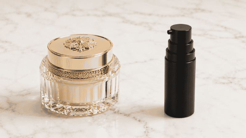 Decorative collagen cream jar beside a functional retinol serum — does collagen cream work compared to collagen-stimulating actives