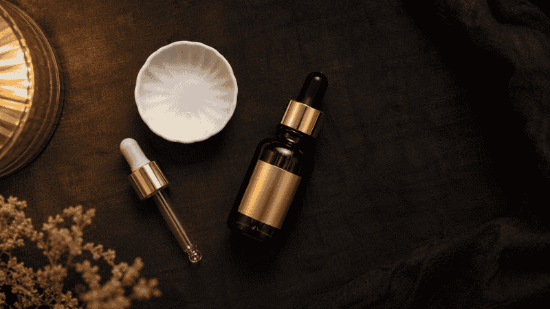 Luxury retinol serum bottle on dark linen surface — how long does retinol take to work for mature skin