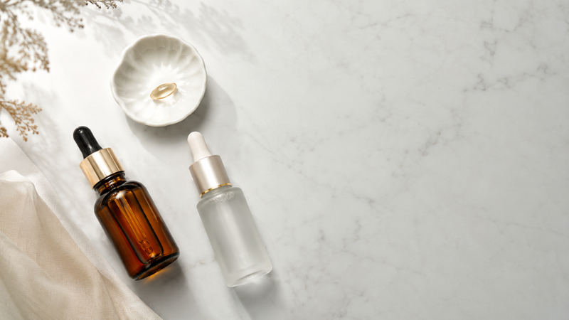 Luxury retinol, peptide and vitamin C serums for improving skin elasticity arranged on marble