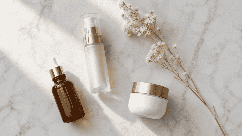 Luxury retinol serum, vitamin C and peptide moisturiser on marble — how to stimulate collagen production with proven skincare ingredients