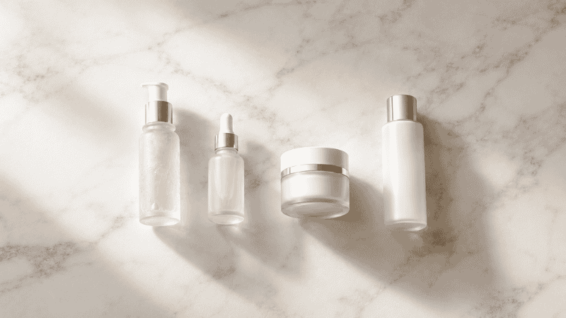 Four essential luxury skincare products with generous space between them — a minimalist anti-aging routine to avoid over-layering