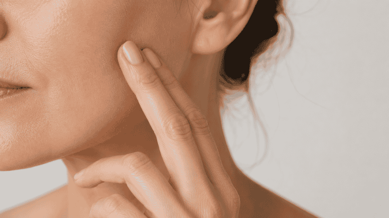 Woman assessing skin texture and firmness while using retinol — week-by-week timeline for mature skin
