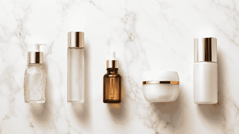 Luxury skincare products arranged in correct layering sequence — serum before or after moisturizer guide for anti-aging routine