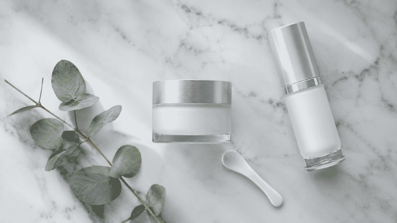 Luxury ceramides moisturizer in frosted glass jar on white marble with eucalyptus — ceramides moisturizer guide for barrier repair in mature aging skin