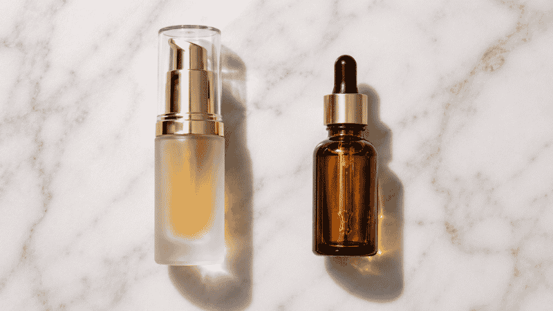 Luxury squalane serum in frosted glass beside simple single-ingredient dropper — is luxury squalane worth more than a basic formula for mature skin