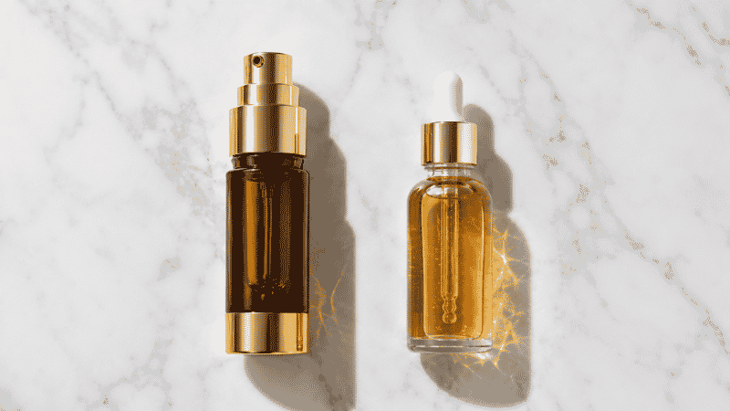 Luxury vitamin C serum in dark airless pump beside clear glass dropper showing oxidised serum — is luxury vitamin C serum worth the premium for packaging technology and stability