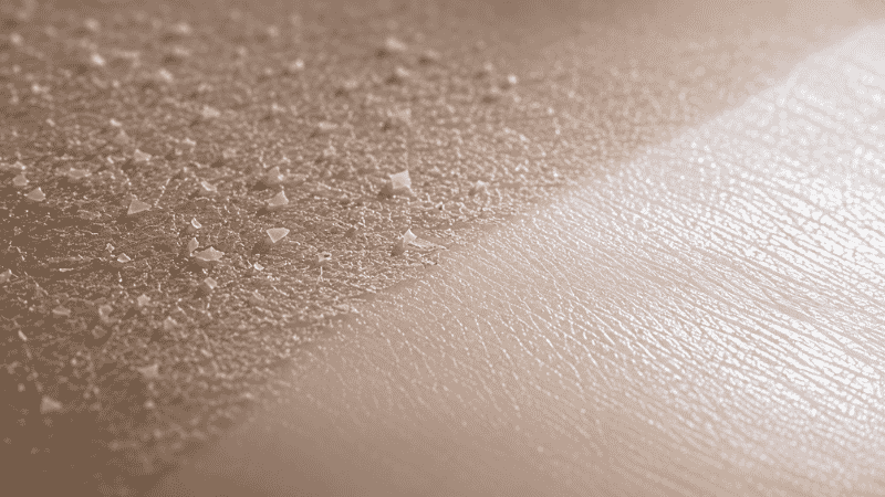 Two skin texture zones showing dull accumulated surface versus luminous renewed skin — glycolic acid dual mechanism of surface exfoliation and collagen stimulation