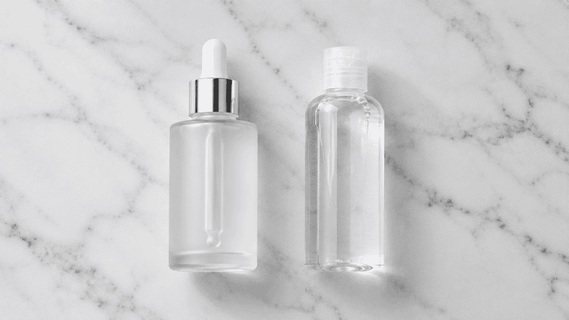 Luxury glycolic acid toner in frosted glass beside standard plastic bottle — is luxury glycolic acid toner worth the premium for mature aging skin