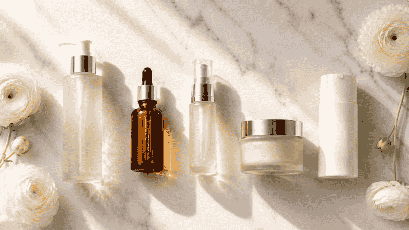 Five luxury skincare products in morning routine sequence on white marble — complete morning skincare routine for women over 40 including vitamin C, ceramides and SPF