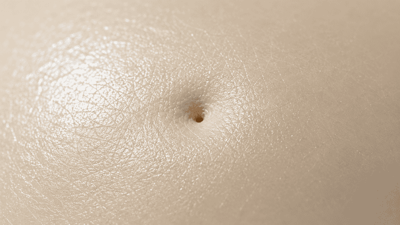 Macro close-up of skin pore in raking side light — the androgen receptor mechanism driving perimenopause acne and sebaceous gland activity in hormonal breakouts