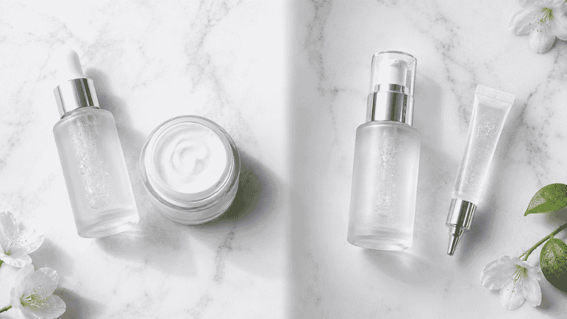 Hydration products beside acne treatment products on white marble — addressing perimenopause dry skin and acne simultaneously with barrier repair and sebum regulation